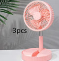 Black portable telescopic folding fan extended to full height on a tabletop