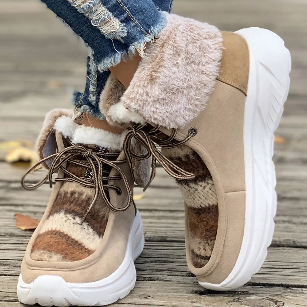 Women's beige lace-up snow boots with a suede upper and thick platform sole.