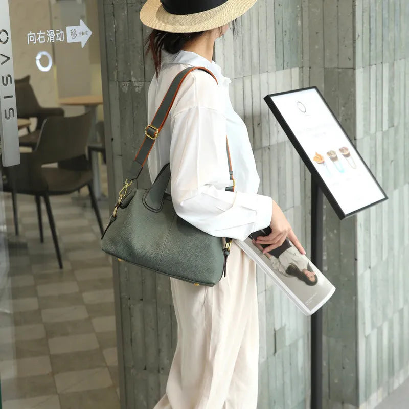 Women's leather cross-body shoulder bag in horizontal square shape with multiple internal zipped compartments