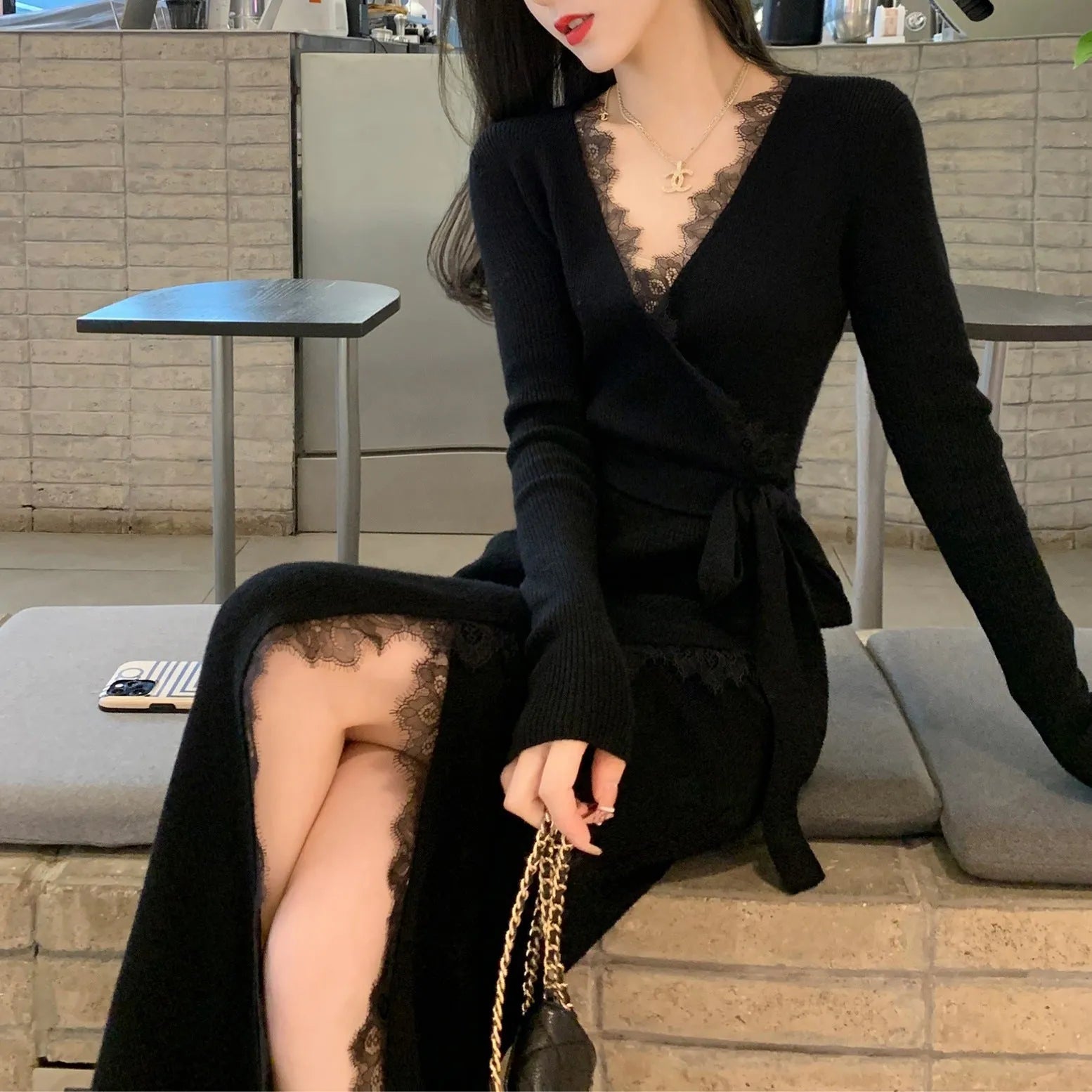 Black women's slim-fit woolen skirt in a princess dress style on a hanger.