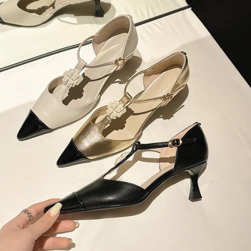 Women's black pointed toe stiletto shoe with flower buckle detail on a 3-5cm heel.
