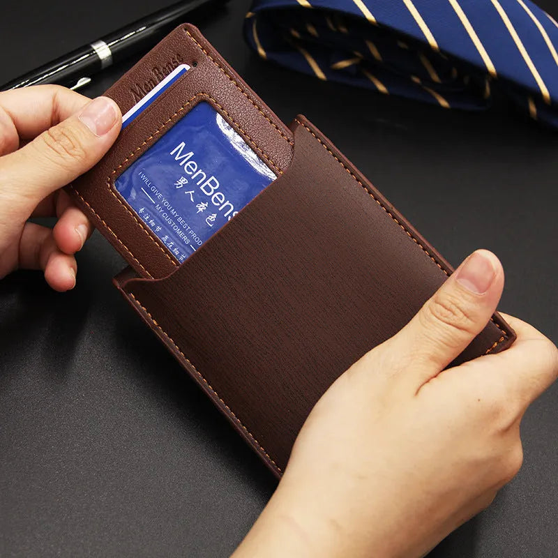Men's black iron-edge card-picking wallet holding banknotes and cards next to a mobile phone