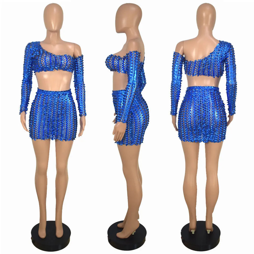 Women's black hollow-out two-piece dress set with sleeveless top and short skirt.