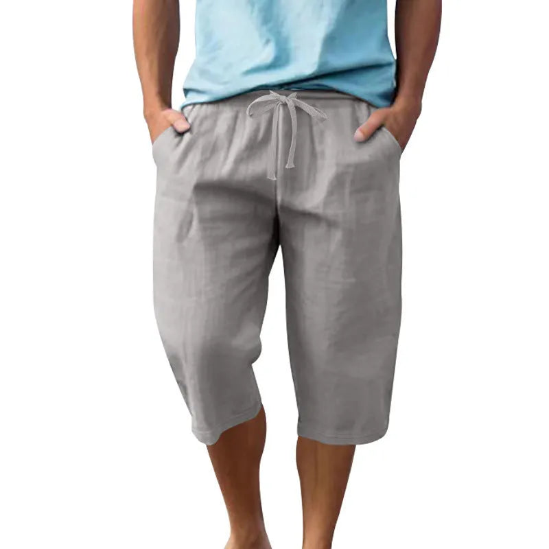 Men's loose fit linen shorts in a solid colour with a high waist and drawstring closure.