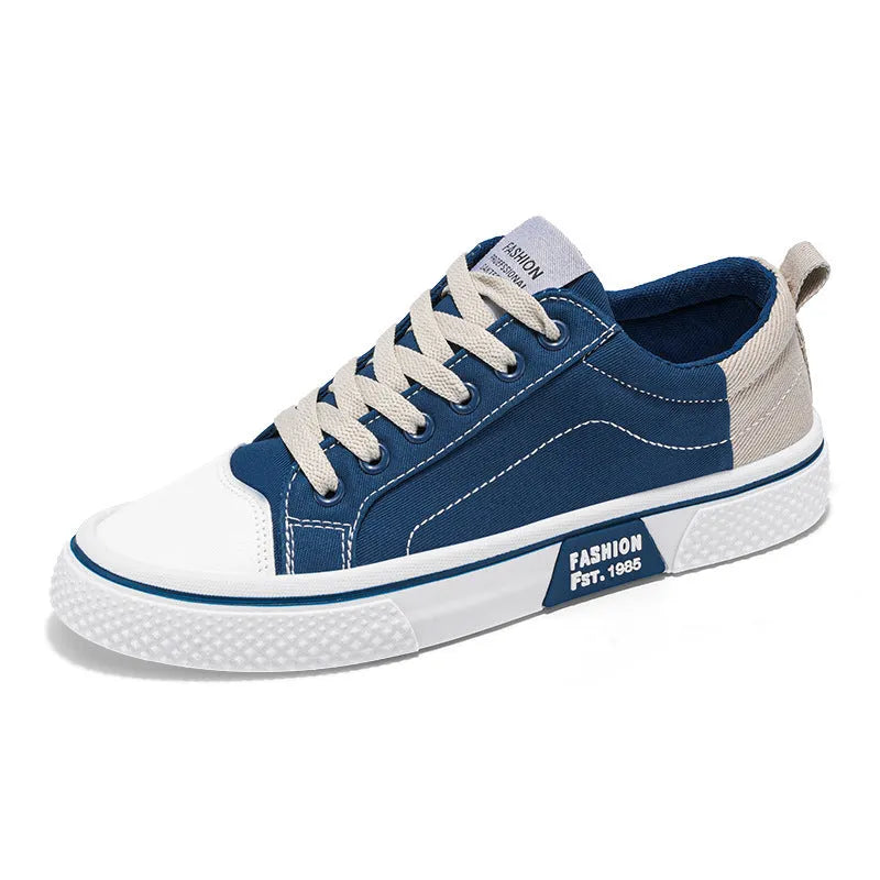 Men's low-top canvas casual shoe in blue with round toe, lace-up front, and soft PVC sole.
