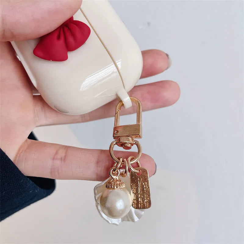 Beige AirPods case with red bow decoration, clamshell design for AirPods Pro and AirPods 3 models