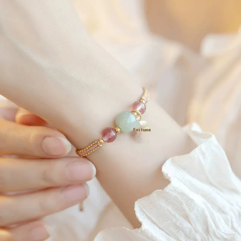 Adjustable red rope bracelet with strawberry quartz transfer beads and sliding knot closure