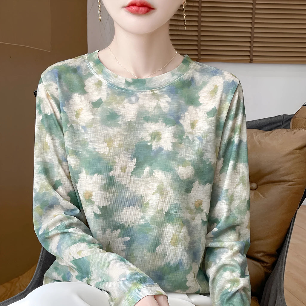 Women's round neck knitted pullover in a Tencel cotton blend with a printed floral design on the front.