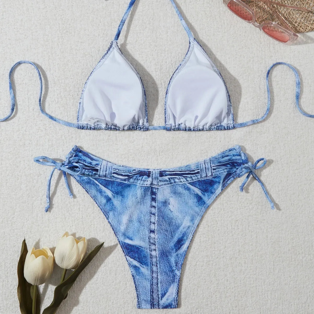 Denim blue women's bikini set with printed strap design on a hanger.