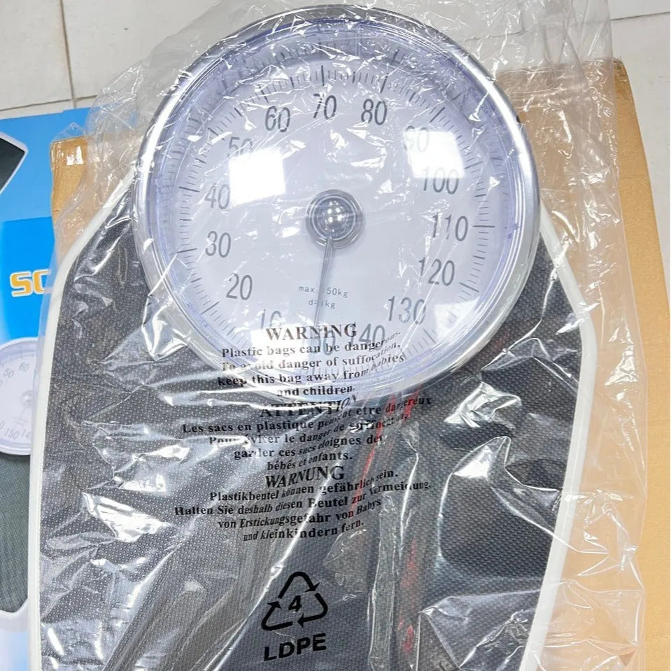 Black mechanical bathroom weight scale with large dial on a 47x35cm platform.