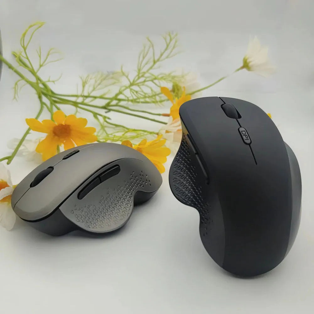 Black and grey wireless computer mouse with USB charger on white background