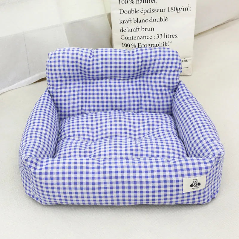 Grey and blue plaid cloth dog car travel nest shown on a car seat, with small and large size options.