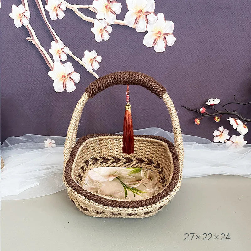 Hand-woven straw basket with hemp rope binding in coffee brown colour, 19cm long by 12cm wide.