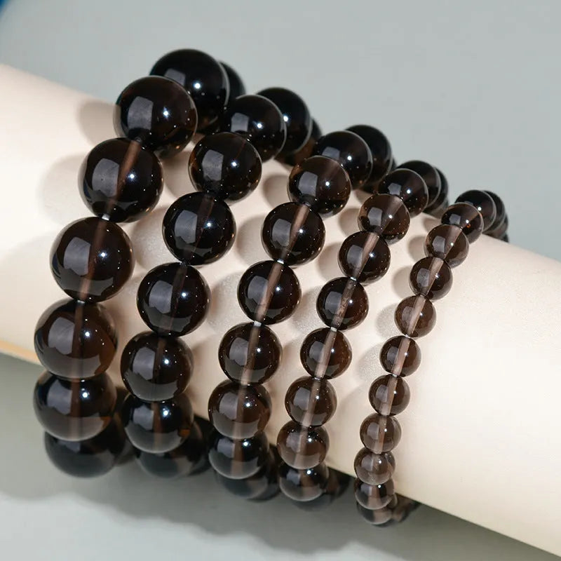 Hand-woven obsidian couple bracelets in various colours including black, silver, and rainbow eye obsidian