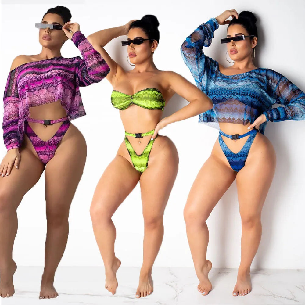 Women's snakeskin print polyester three-piece bikini suit showing long sleeve top, shorts and matching bottoms