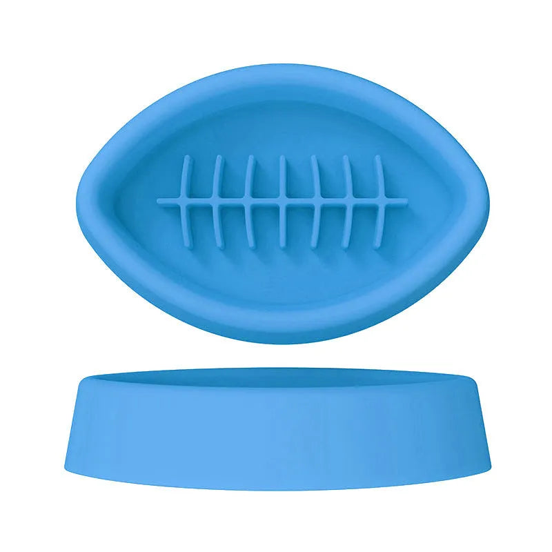 Blue silicone slow feeder pet bowl with ridges and a suction cup base on a floor.