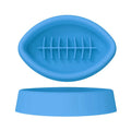 Blue silicone slow feeder pet bowl with ridges and a suction cup base on a floor.