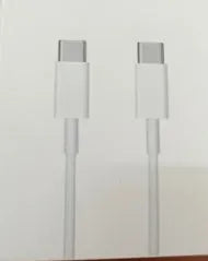 White 20W USB-C PD fast charger with UK plug and a coiled charging cable.