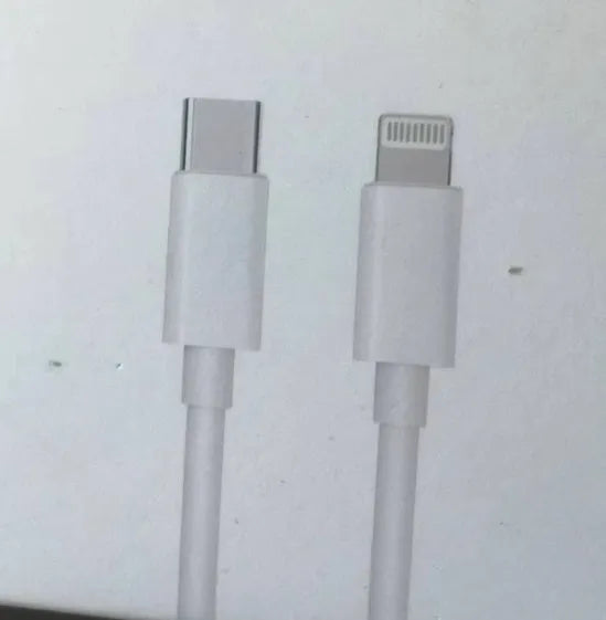 White 20W USB-C PD fast charger with UK plug and a coiled charging cable.