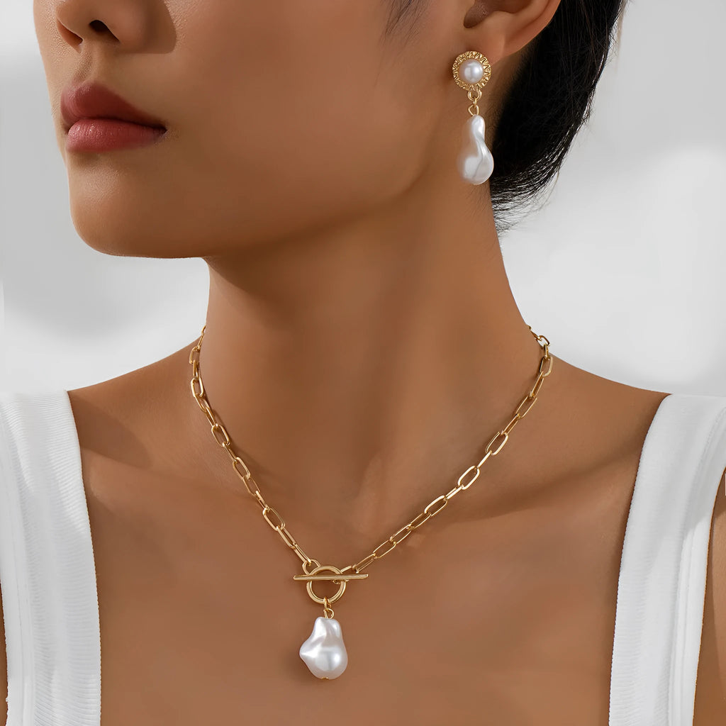 Gold colour baroque pearl necklace and earring set with retro design on dark background