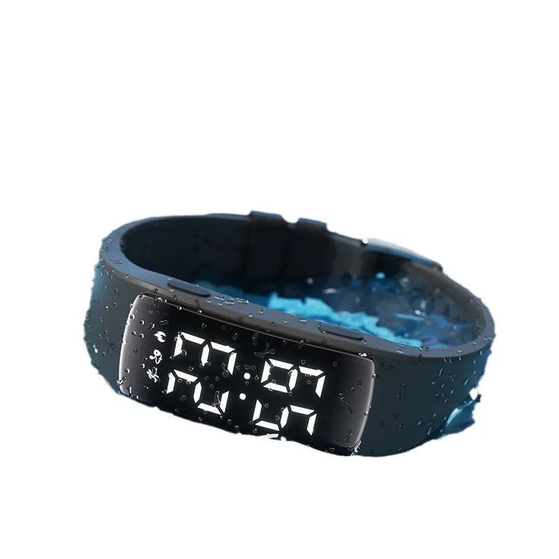 Vibration alarm smart watch with coloured silicone strap and LED display on a wrist.