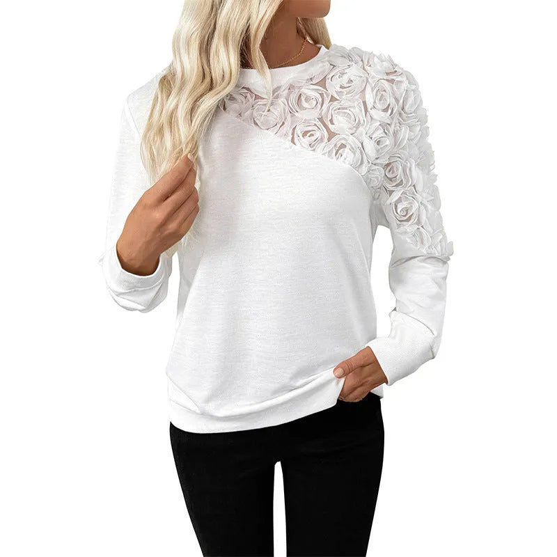 White women's long sleeve floral print top with loose fit on a hanger.