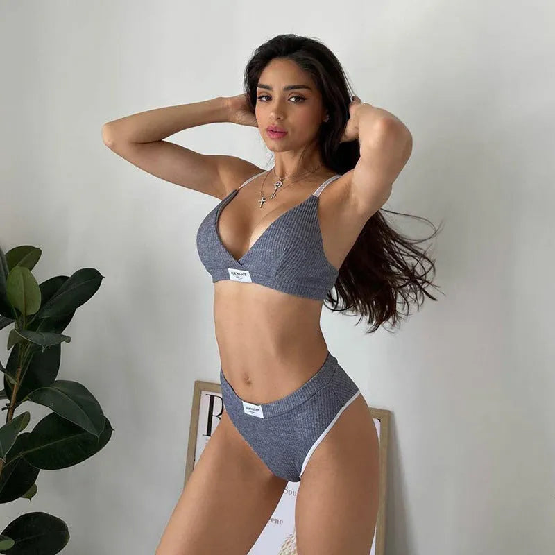 Women's grey bikini set with contrast binding embroidery detail showing sleeveless top and shorts