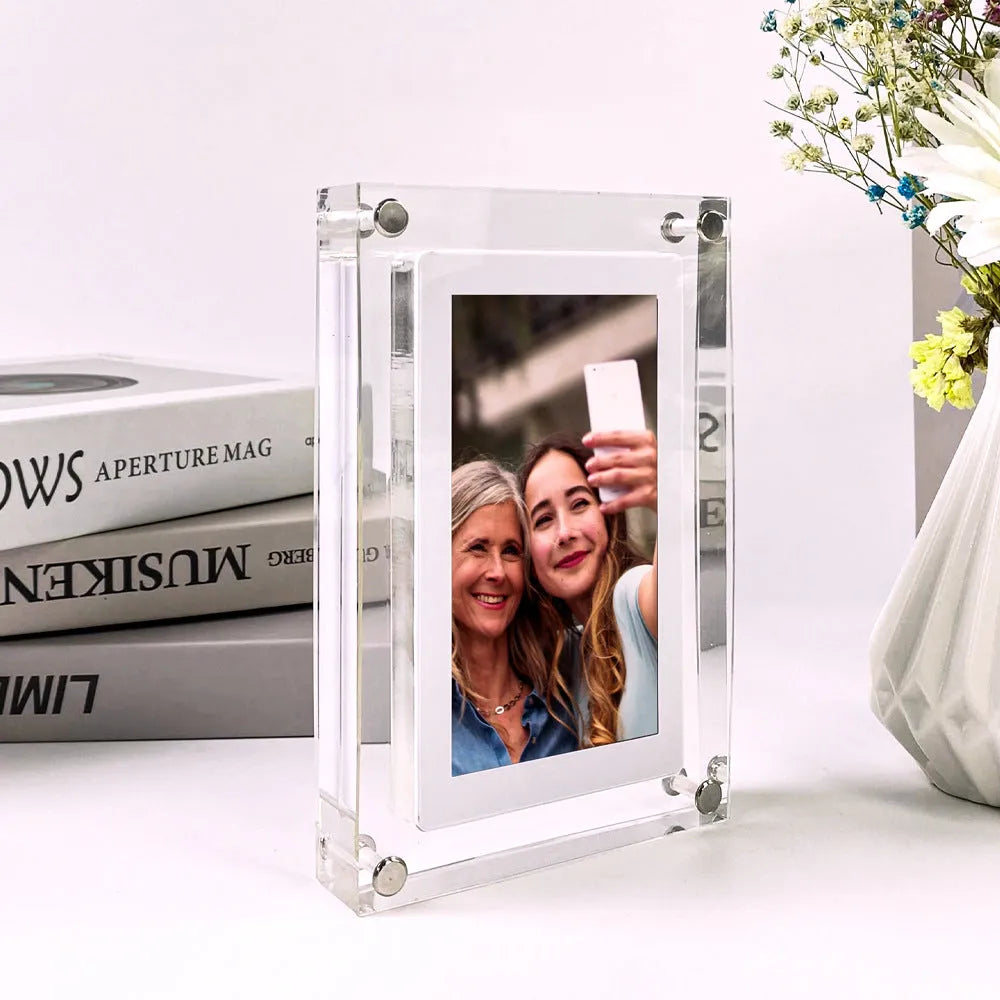 White acrylic digital picture frame showing family photos on a 5-inch vertical screen