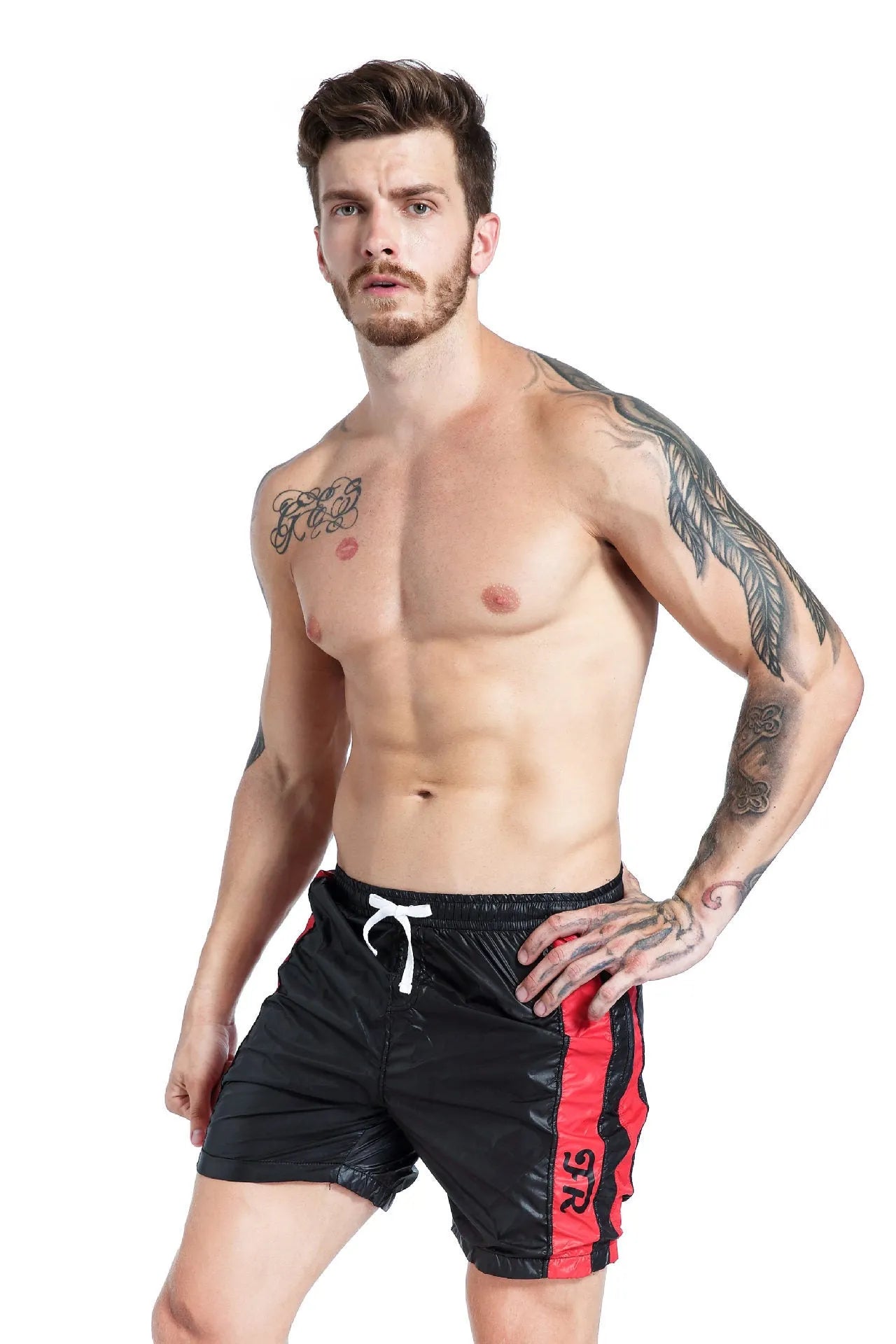 Man wearing blue slim-fit sports shorts with a lace-up front and padding.