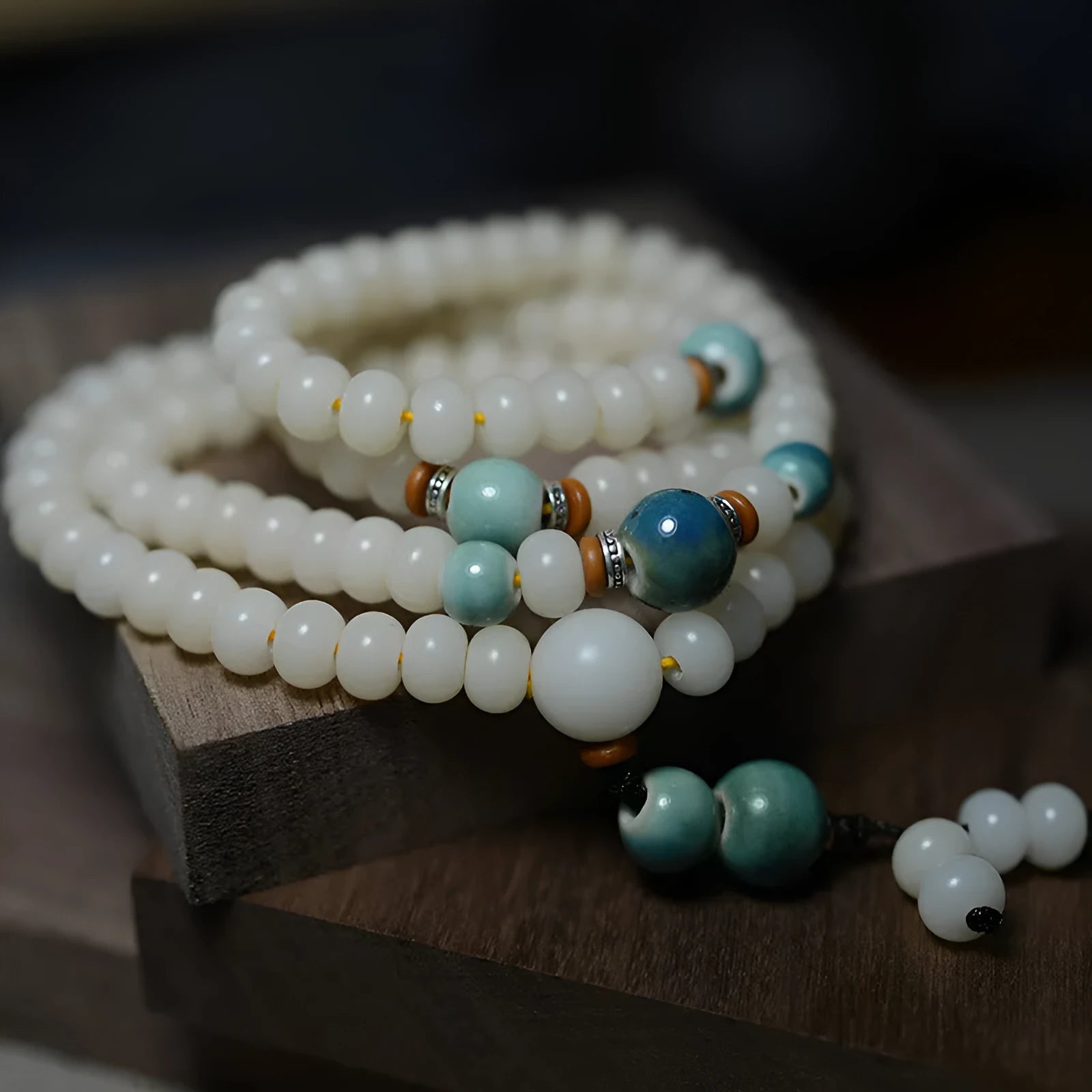 White jade and bodhi seed beaded bracelet with 108 flat round beads in four sizes.