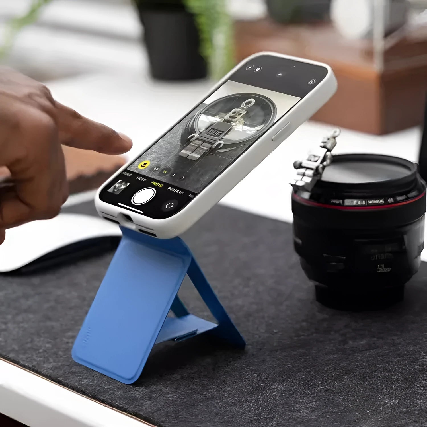 Black magnetic mobile phone holder case on a car dashboard, showing compact size and magnetic plate.