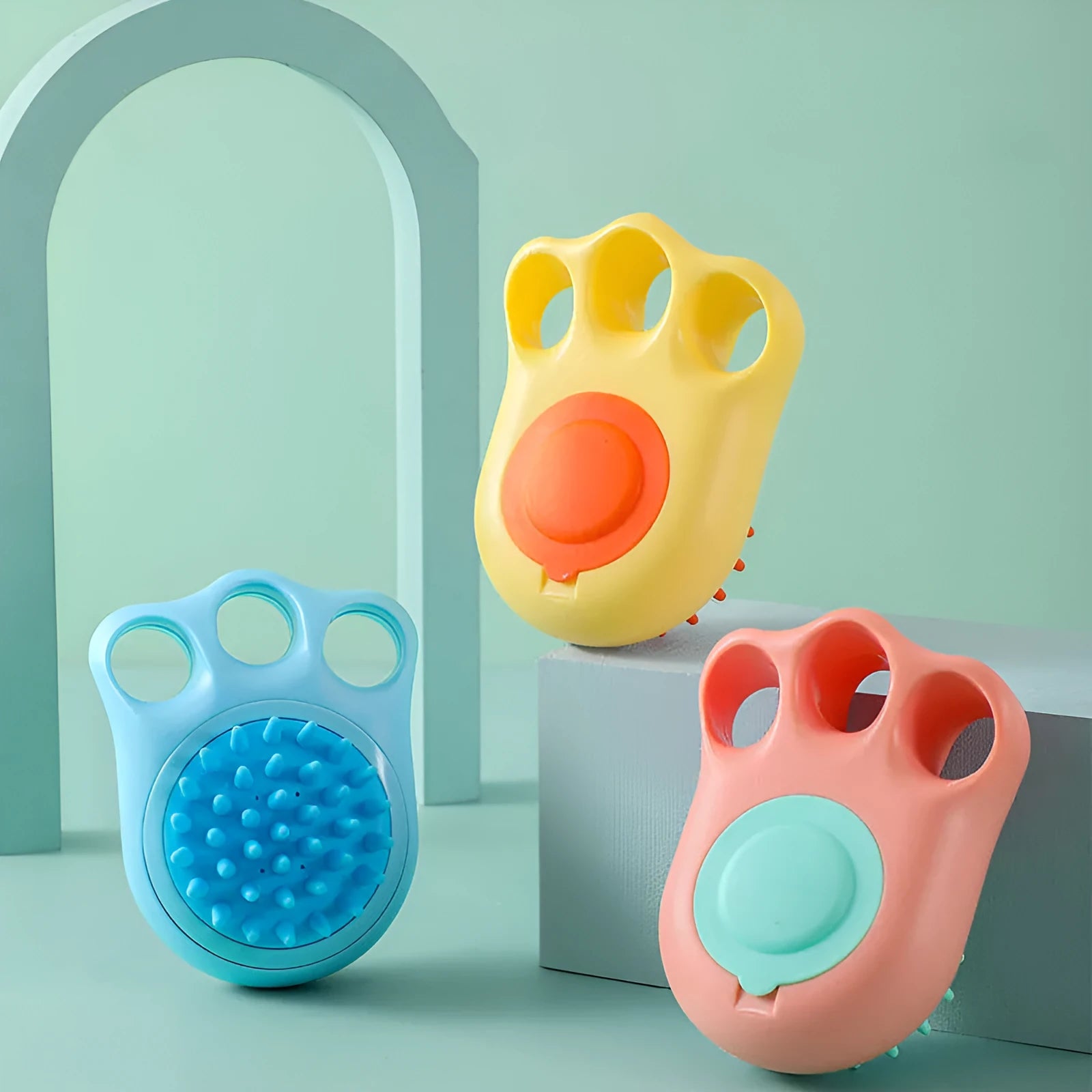 Blue silicone claw pet bath brush for washing cats and dogs on a white background.