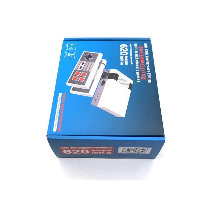 Compact black NES 8-bit retro game console with two rectangular controllers on a grey surface.