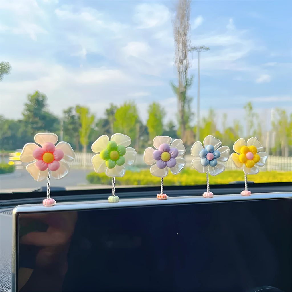 Small colourful plastic swing car decoration for hanging on rear view mirror.