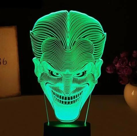 USB-powered 3D acrylic LED lamp displaying multiple colours, shown with its remote control and stand.