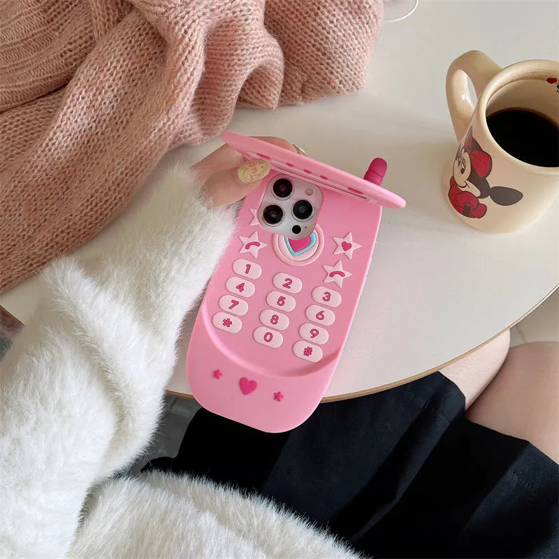 Pink silicone iPhone case with a flip-open mirror cover on a table.