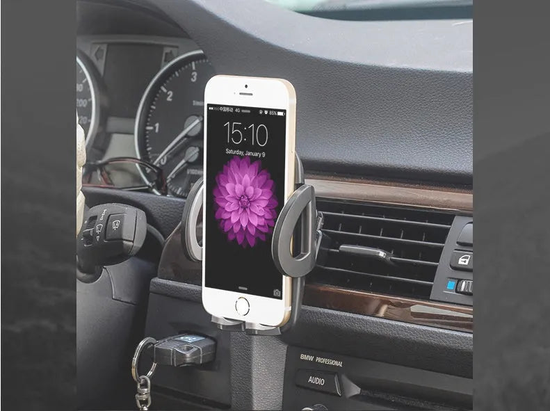 Black car phone holder clipped to air conditioning vent with smartphone secured in adjustable bracket