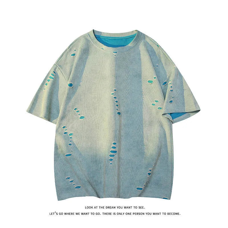 Men's blue loose-fit distressed short-sleeve t-shirt with ripped fabric detailing on a casual backdrop.