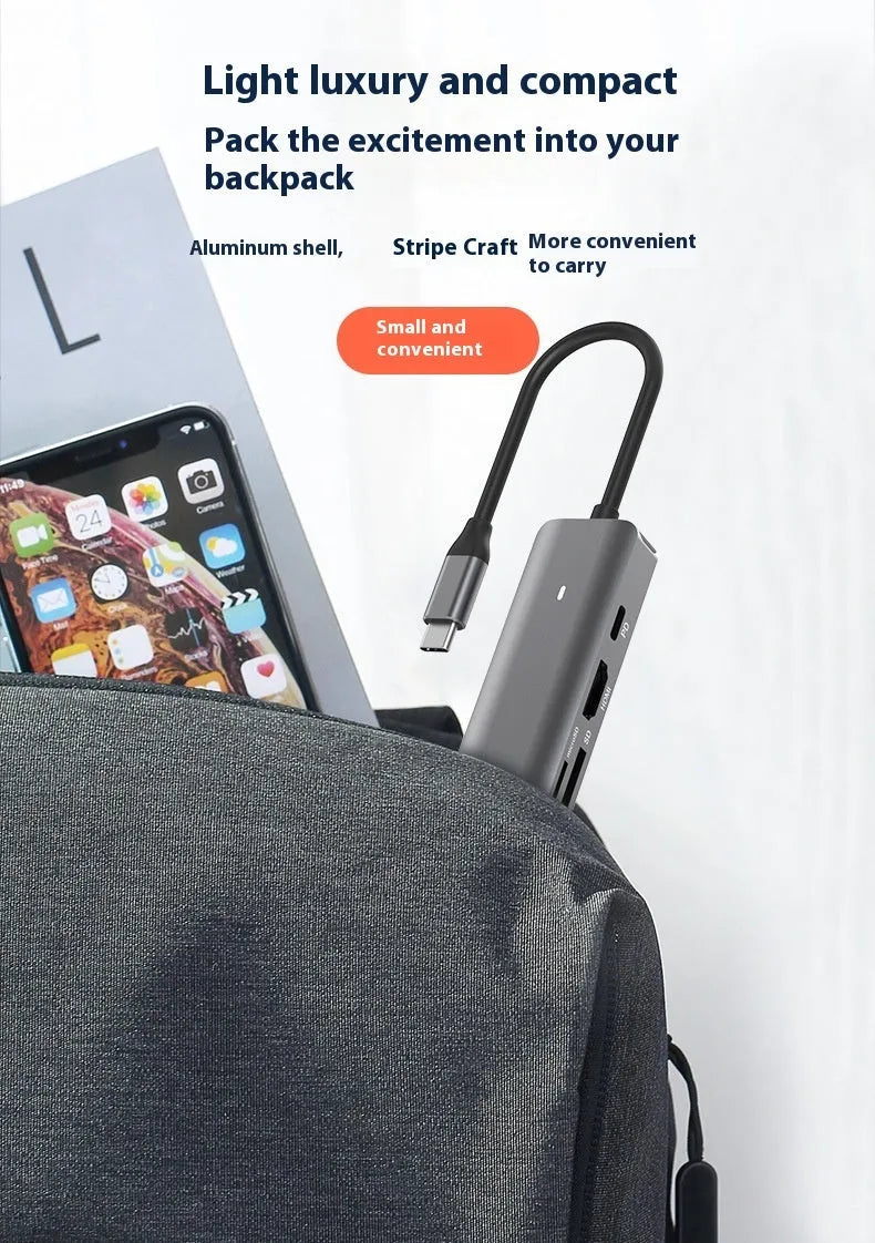LQT-LH07 7-in-1 USB-C computer hub with card readers and charging port on a desk.