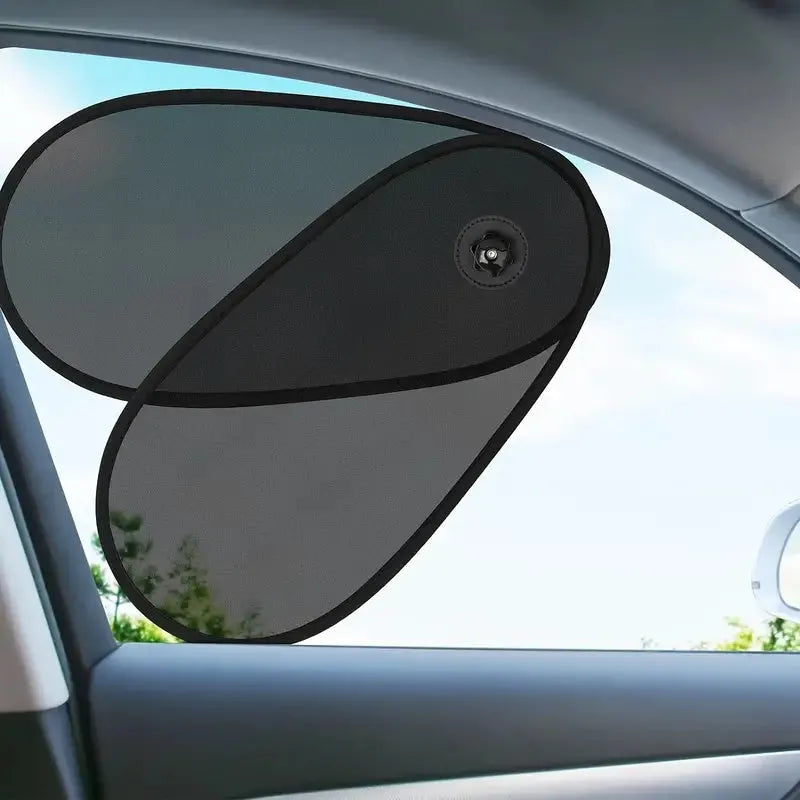 Black stretchy car side window shade with suction cups attached to glass, shown in a collapsed state.