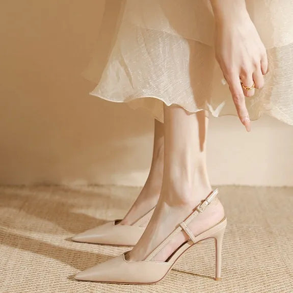 Apricot women's high-heeled sandals with a buckle toe strap and thin belts on a rubber sole.