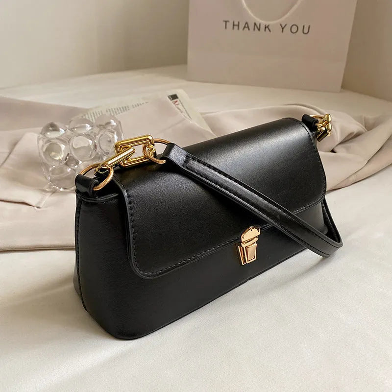 Brown French style casual underarm bag with a single shoulder chain, showing sandwich pocket and sewing thread detail.