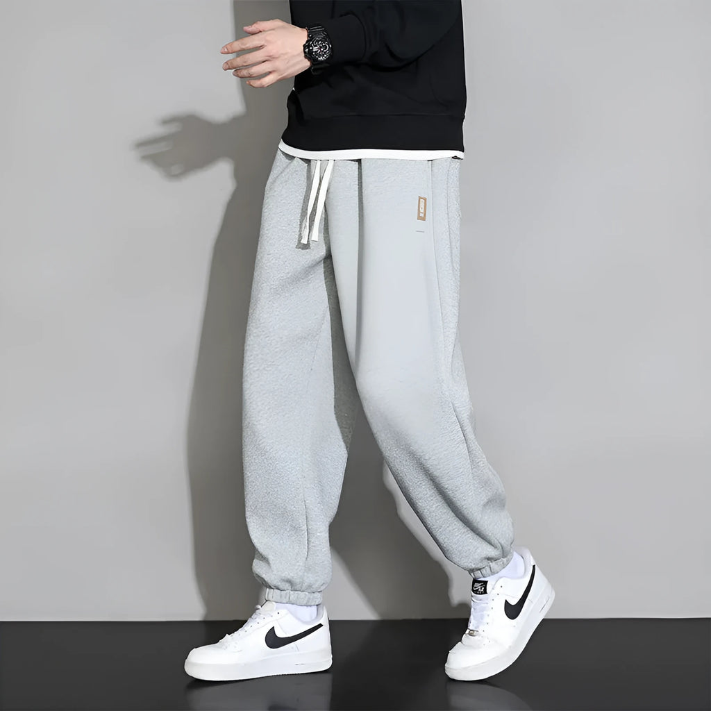 Men's loose fit grey cotton sports trousers with elastic waistband and drawstring closure