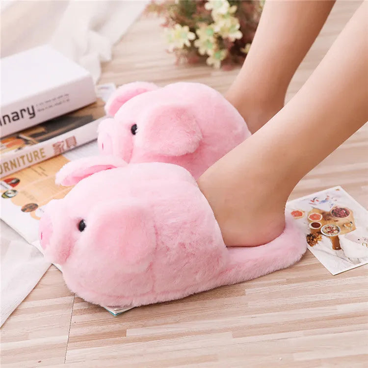 Pink pig-shaped plush floor slippers with short plush exterior.