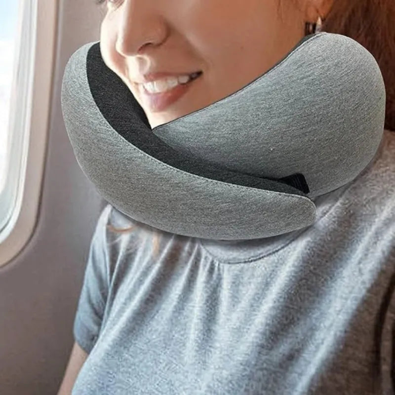 U-shaped memory foam travel neck pillow in navy blue with buckle fastening, shown rolled with carry bag