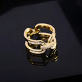Round copper scarf ring with electroplated gold finish, geometric shape, on a silk scarf