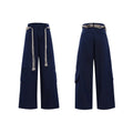Men's dark coloured straight-leg jeans with heavy 3D cutting, belt-loop stitching, and decorative zipper details