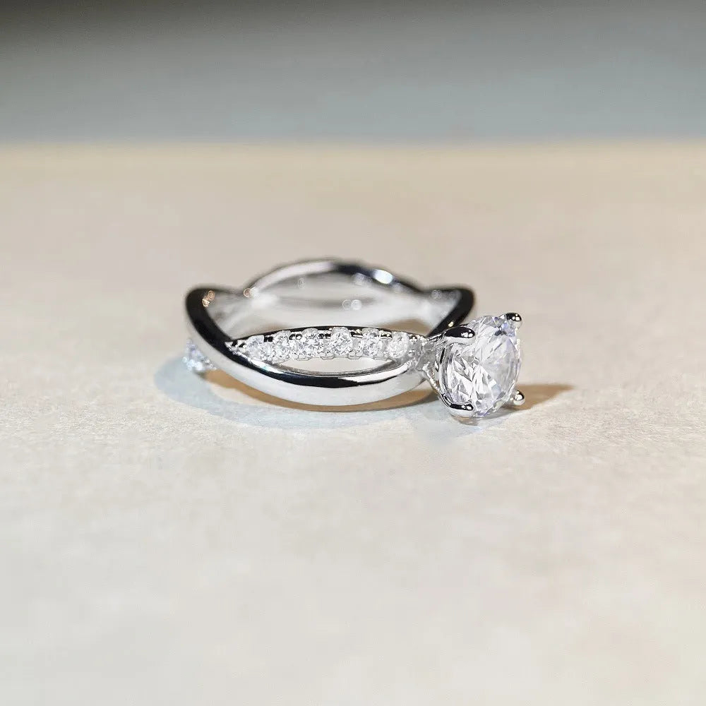 Geometric twist arm silver ring with 1 karat moissanite stone in four-claw winding setting