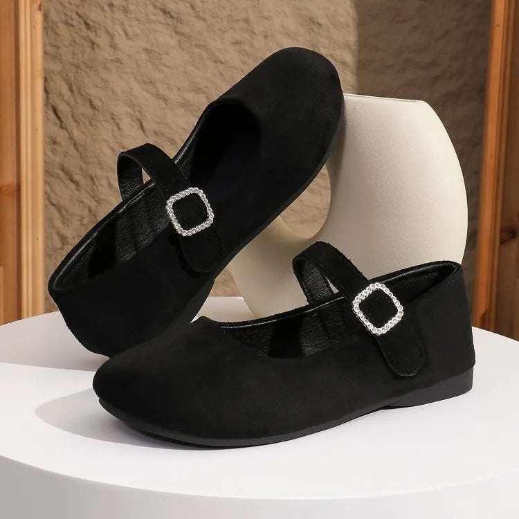 Black canvas men's fisherman shoes with a flat rubber sole, shown from the side.