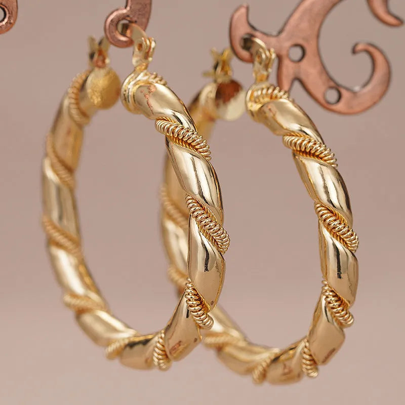 Women's copper geometric earrings with ring and line design elements in gold colours